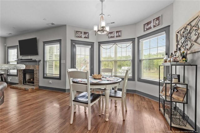 2677 Cypress Lakes Rd, Hope Mills, NC 28348 - dining space featuring a chandelier, baseboards, and wood finished floors