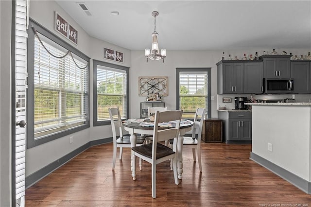 2677 Cypress Lakes Rd, Hope Mills, NC 28348 - dining room featuring a chandelier, dark wood-style floors, and baseboards
