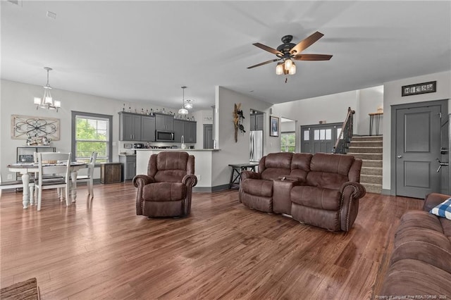 2677 Cypress Lakes Rd, Hope Mills, NC 28348 - living room with wood finished floors, a chandelier, ceiling fan, stairway, and baseboards