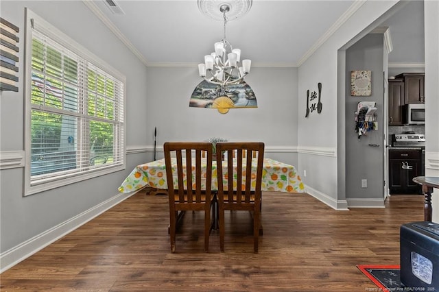 dining room with a chandelier, dark wood-style flooring, crown molding, and baseboards