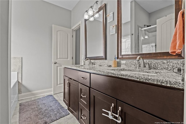 full bathroom with a stall shower, a garden tub, tile patterned flooring, and double vanity