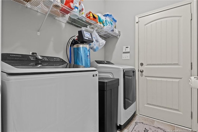 washroom featuring separate washer and dryer and light tile patterned flooring