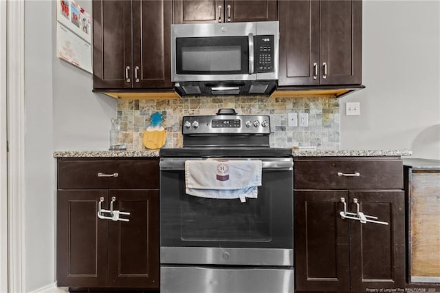 kitchen with appliances with stainless steel finishes, dark brown cabinetry, tasteful backsplash, and light stone countertops