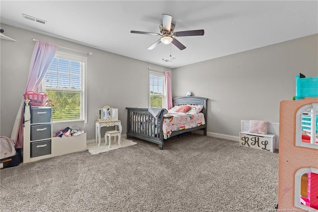 carpeted bedroom featuring ceiling fan and baseboards