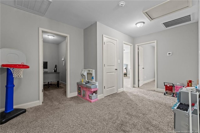 recreation room with carpet flooring, attic access, baseboards, and an office area