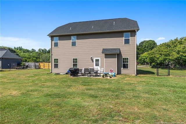rear view of house featuring a patio and a gate