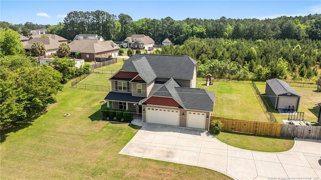 aerial view of property and surrounding area with a heavily wooded area
