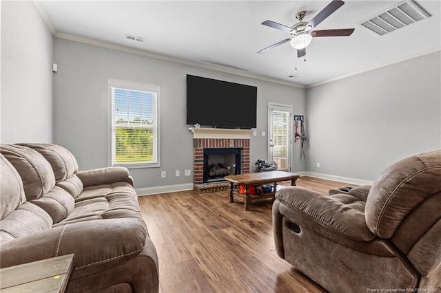 2671 Cypress Lakes Rd, Hope Mills, NC 28348 - living room featuring wood finished floors, ceiling fan, baseboards, ornamental molding, and a brick fireplace