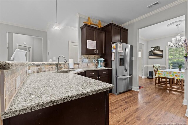 2671 Cypress Lakes Rd, Hope Mills, NC 28348 - kitchen featuring stainless steel fridge with ice dispenser, a sink, a chandelier, dark brown cabinets, and light wood finished floors