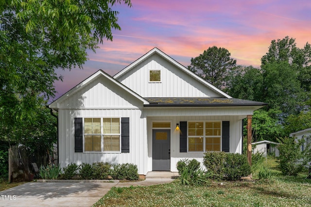 303 Godwin St, Selma, NC 27576 - view of front facade featuring board and batten siding, a porch, and a shingled roof