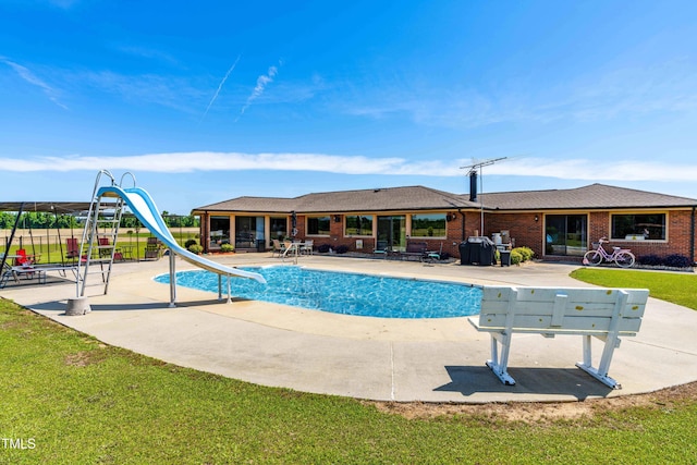 3187 Wilsons Mills Rd, Smithfield, NC 27577 - view of pool featuring a water slide, a patio, and a yard