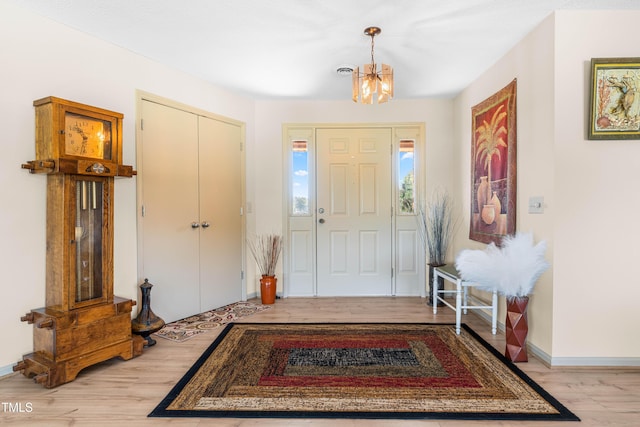 3187 Wilsons Mills Rd, Smithfield, NC 27577 - foyer entrance with a chandelier, light wood-style floors, and baseboards