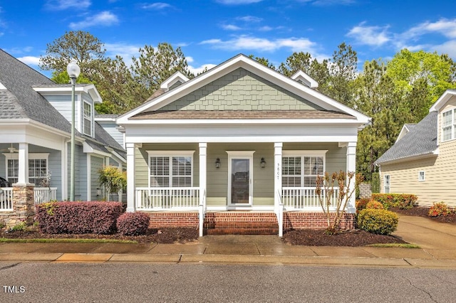 view of front of property with a porch and a shingled roof