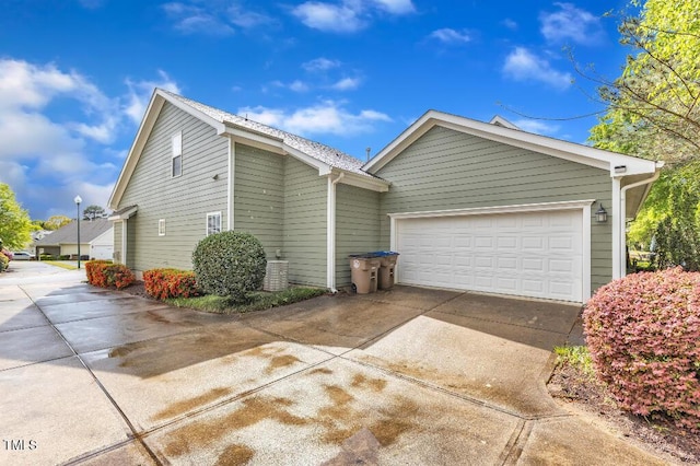 view of side of home with concrete driveway