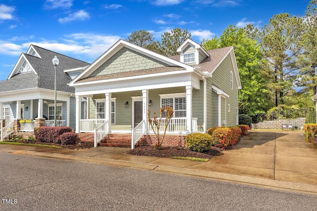 view of front of home featuring covered porch and roof with shingles