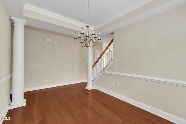 unfurnished dining area featuring a chandelier, crown molding, wood finished floors, stairway, and baseboards