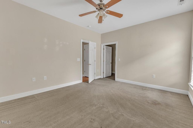 unfurnished room with a ceiling fan, carpet floors, and baseboards