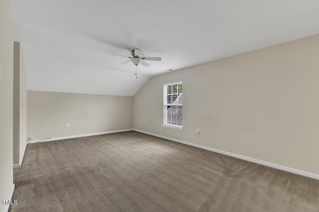 bonus room featuring ceiling fan, carpet flooring, baseboards, and vaulted ceiling