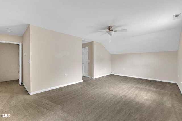 additional living space with a ceiling fan, carpet flooring, baseboards, and vaulted ceiling