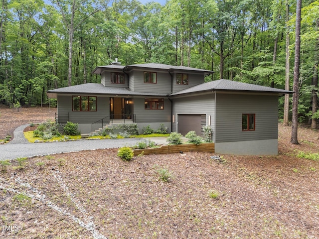 1115 Trailwood Dr, Raleigh, NC 27606 - prairie-style house with driveway, a garage, a chimney, and covered porch