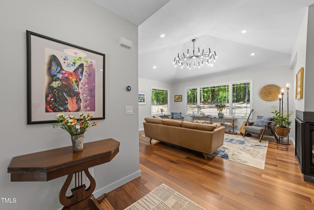 1115 Trailwood Dr, Raleigh, NC 27606 - living room featuring lofted ceiling, light wood-style flooring, healthy amount of natural light, a chandelier, and recessed lighting