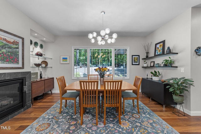 1115 Trailwood Dr, Raleigh, NC 27606 - dining space featuring a chandelier, wood finished floors, a high end fireplace, and baseboards