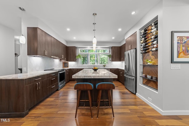 1115 Trailwood Dr, Raleigh, NC 27606 - kitchen featuring stainless steel appliances, dark brown cabinets, dark wood-type flooring, a kitchen island, and recessed lighting