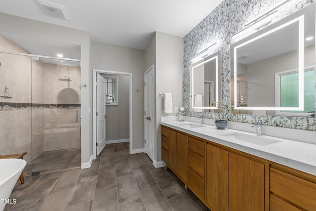 1115 Trailwood Dr, Raleigh, NC 27606 - bathroom with a stall shower, baseboards, double vanity, and a freestanding bath