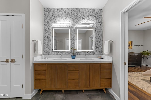 1115 Trailwood Dr, Raleigh, NC 27606 - full bathroom featuring double vanity, baseboards, ceiling fan, and a closet