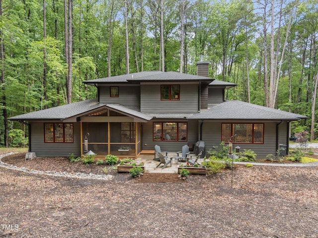 1115 Trailwood Dr, Raleigh, NC 27606 - rear view of house with a chimney, a patio area, a sunroom, and roof with shingles