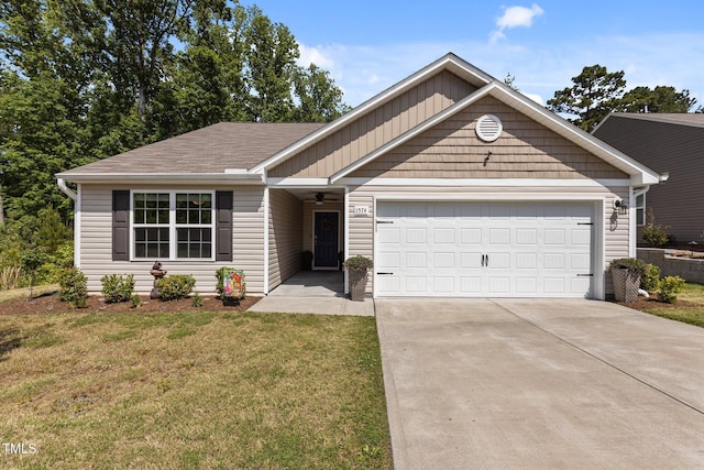 view of front of home featuring driveway, an attached garage, a front yard, and roof with shingles