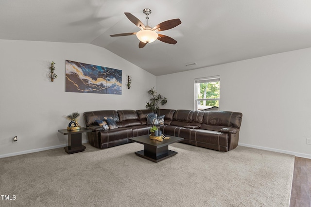 living area with vaulted ceiling, ceiling fan, and baseboards