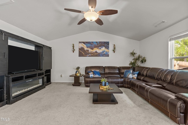 carpeted living room featuring vaulted ceiling, a ceiling fan, and baseboards