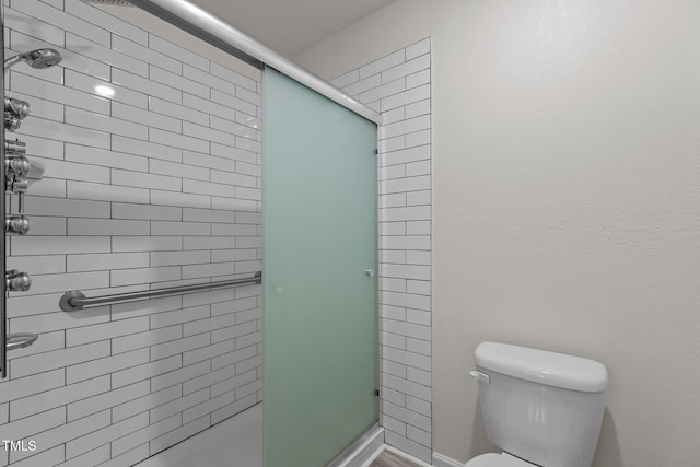 full bathroom with a stall shower and toilet