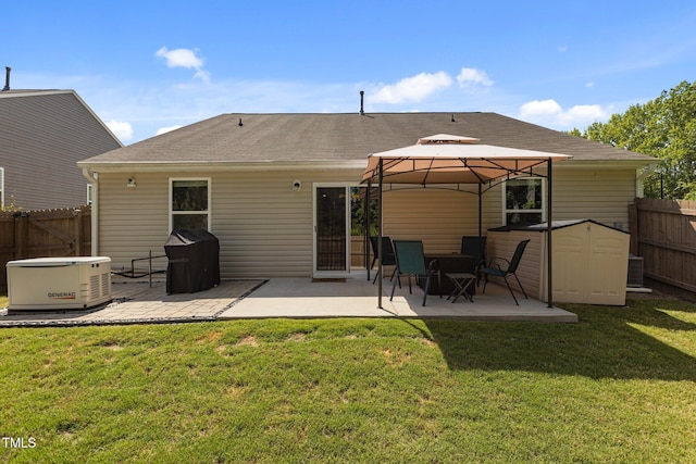 rear view of property with a gazebo, a patio, a storage shed, and a shingled roof