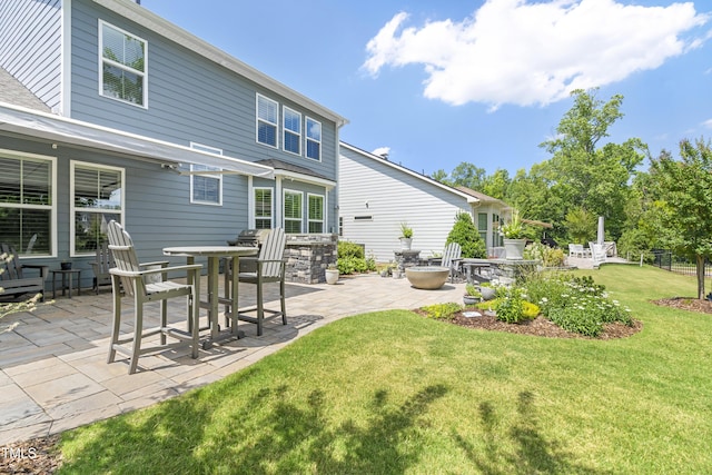 back of house with a lawn and a patio