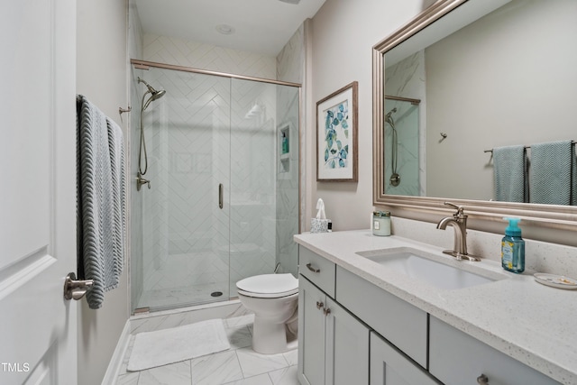 bathroom featuring a stall shower, toilet, vanity, and marble look tile flooring
