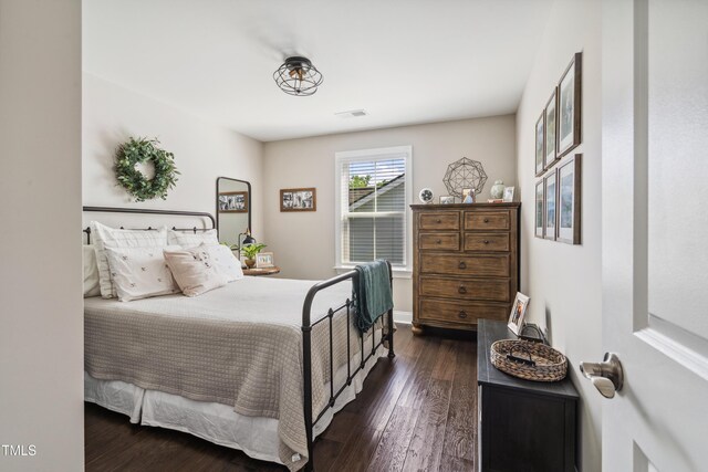 bedroom with dark wood finished floors