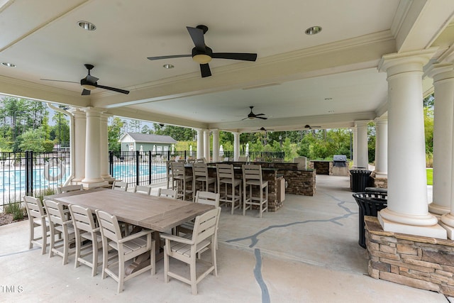 view of patio with fence and a ceiling fan
