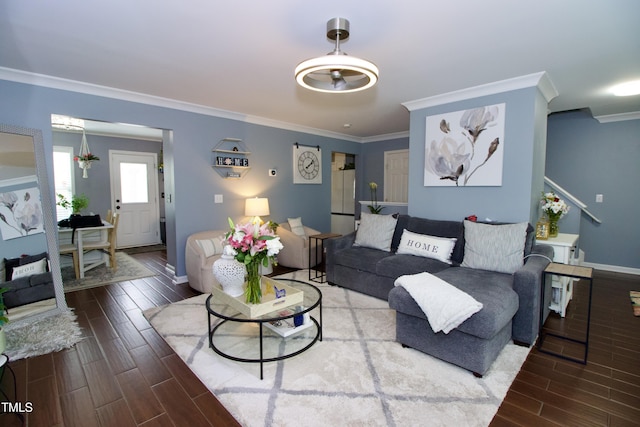living room with wood tiled floors, crown molding, and baseboards