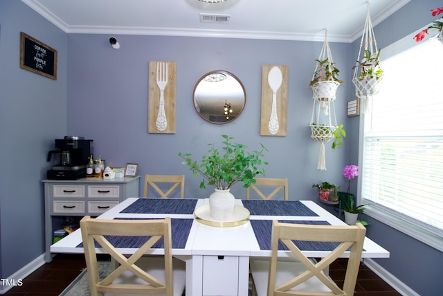 dining area featuring baseboards, wood finish floors, and crown molding