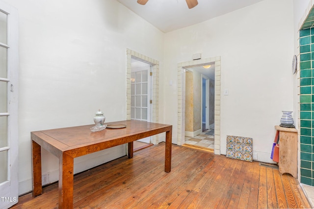 hallway with hardwood / wood-style flooring