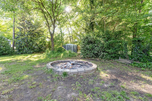 view of yard with an outdoor fire pit