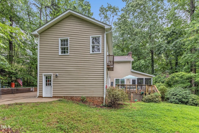 5805 Bayberry Ln, Raleigh, NC 27612 - rear view of house with a patio, a deck, a sunroom, and a yard