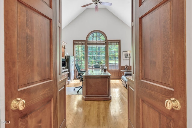 office space featuring light wood finished floors, a ceiling fan, and high vaulted ceiling
