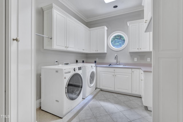 laundry room with cabinet space, separate washer and dryer, ornamental molding, and light tile patterned floors