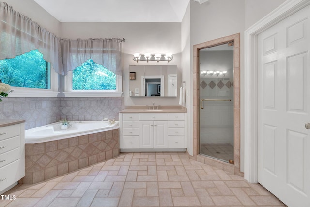 bathroom with vanity, a stall shower, and a bath