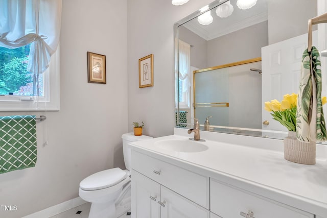 bathroom with vanity, a stall shower, crown molding, toilet, and baseboards