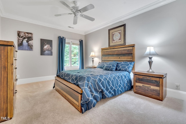 carpeted bedroom with crown molding, baseboards, and ceiling fan