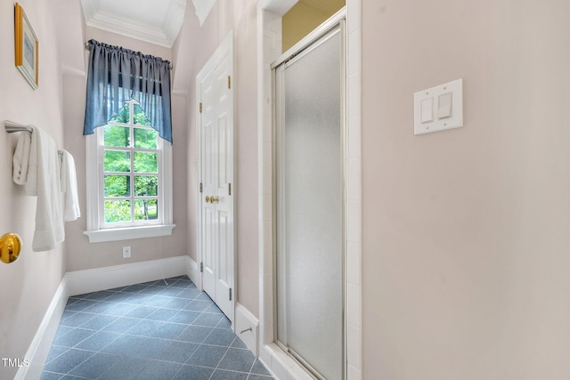 full bathroom featuring a shower stall, ornamental molding, baseboards, and tile patterned flooring